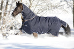 Horseware Rambo Duo Plus Turnout deken in Navy, zijaanzicht op het paard in de sneeuw