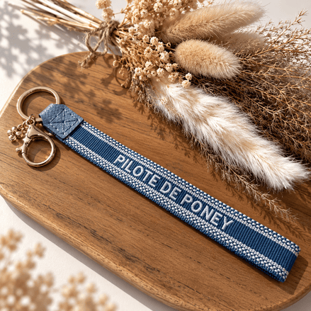 Equestrian Jewelry sleutelhanger Pilote de poney in geborduurde stof met goudkleurige ringen