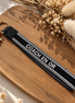 Equestrian Jewelry sleutelhanger Coach en or in stevig lint met geborduurde tekst en goudkleurige ringen
