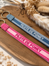 Equestrian Jewelry sleutelhanger Pilote de poney in geborduurde stof met goudkleurige ringen