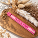 Equestrian Jewelry sleutelhanger Pilote de poney in geborduurde stof met goudkleurige ringen